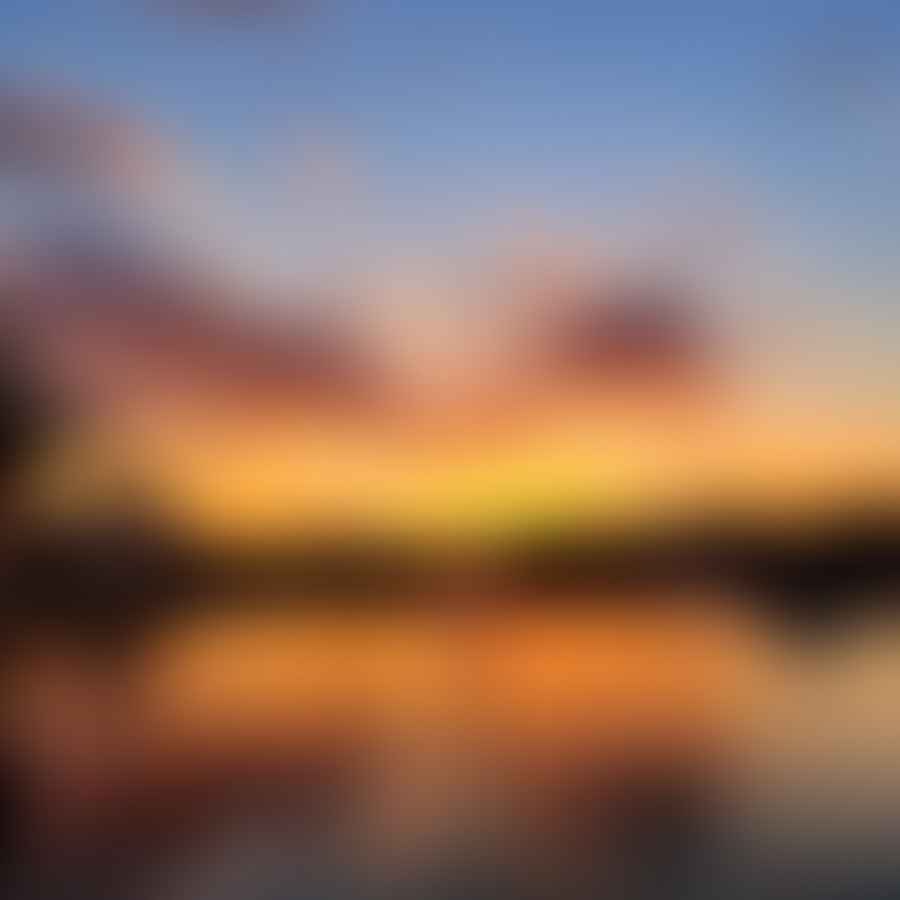 Sunset over Disney Springs with colorful sky reflecting on the water